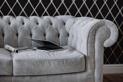 kaboompics Silver laptop and an iPhone on a grey sofa